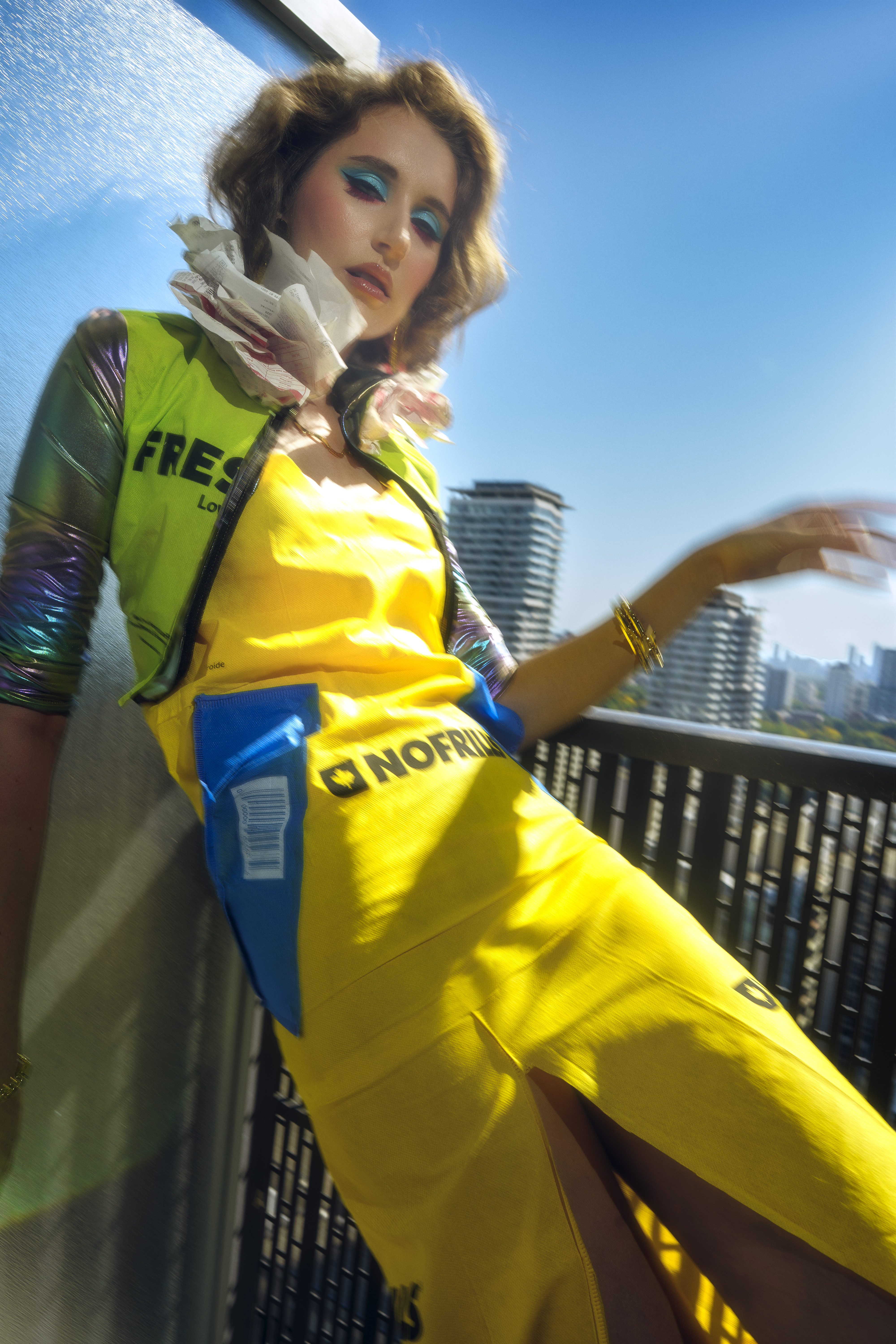 editorial fashion photography Toronto rooftop — model in yellow FreshCo dress with iridescent styling, urban fashion shoot by Daniyar Sadykov